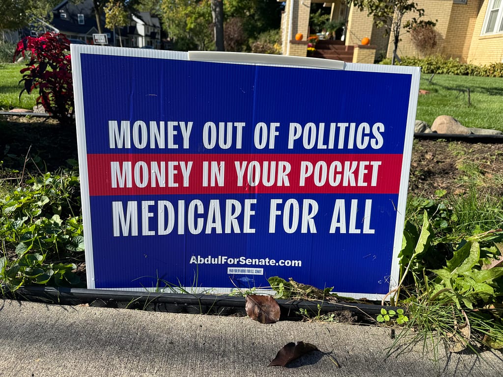 An Abdul yard sign calling for money out of politics, money in your pocket, and medicare for all.