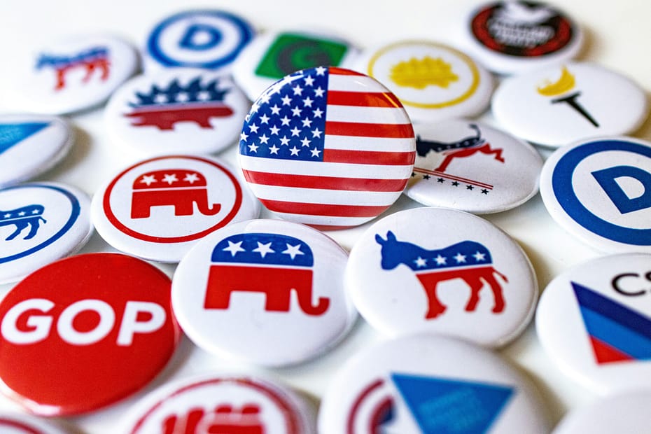 a collection of political buttons overshadowed by postliberalism